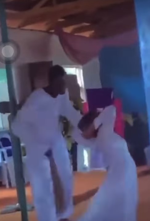 Video of pastor casting out the d€mon in his female member's body with broom sparks reaction online (VIDEO)