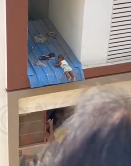 Baby decides to reunite community as the climbs to the roof of a story building (VIDEO)