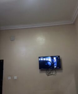 "Hotel wey dey find comfort for you" – Male corps member astonished over the switch of the television in a cheap hotel in Enugu state (VIDEO)